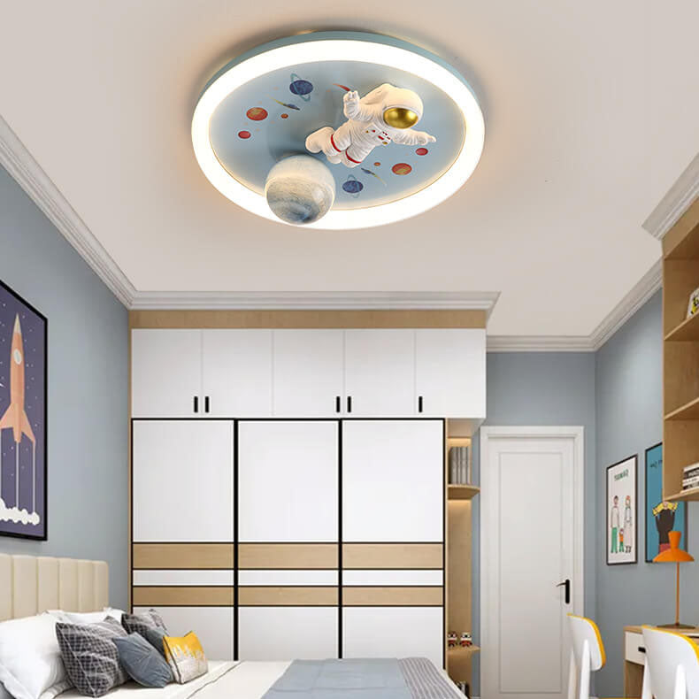 07-16521325-199a-422b-83a8-108626c056f8.jpg Childlike Cartoon Resin Astronaut Round Acrylic LED Flush Mount Ceiling Light - Image 1